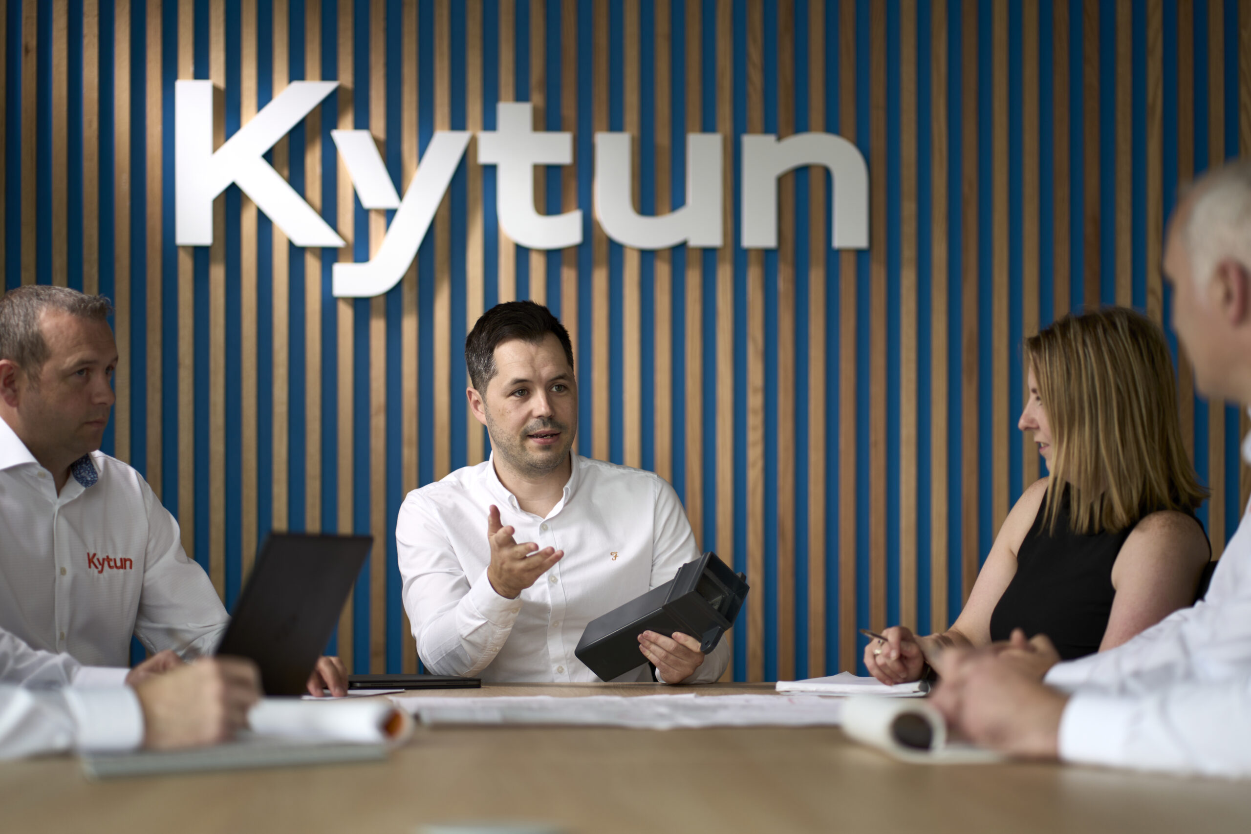 Kytun staff around the boardroom table showing guttering product